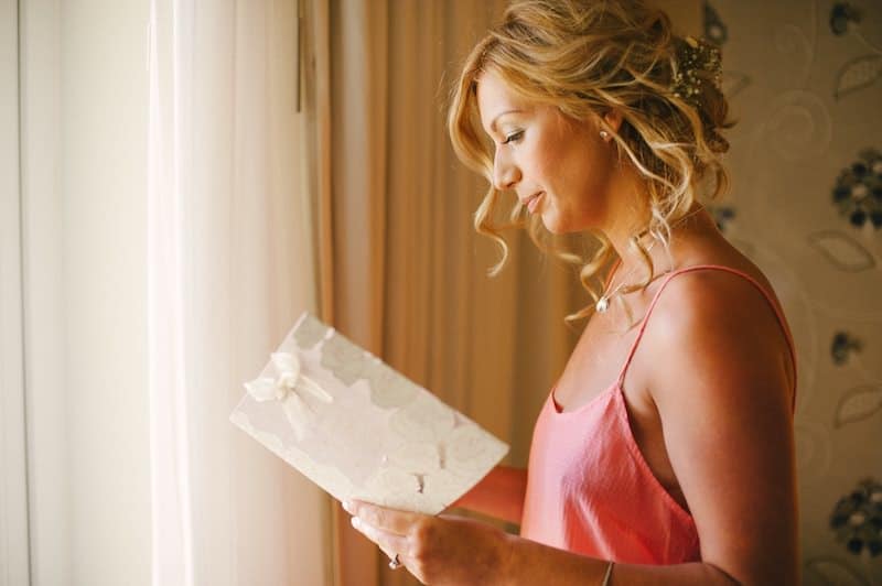 portrait of bride reading a note from groom