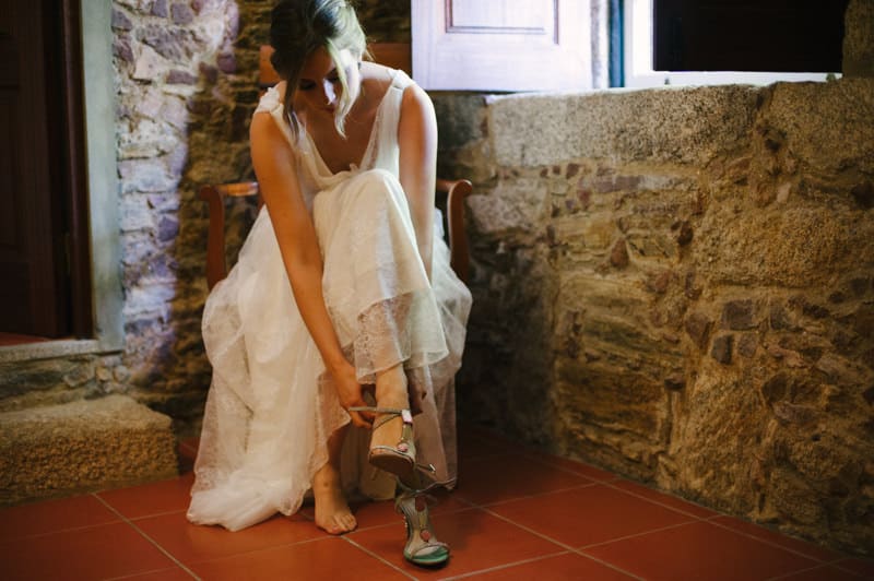 bride putting her shoes on