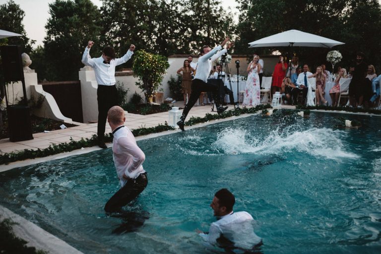 groomsmen bring thrown in pool during casa rupi wedding