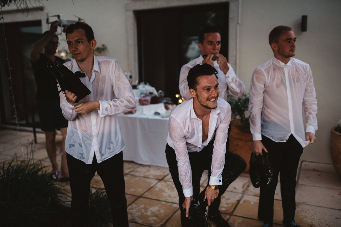 wet groomsmen at casa rupi after jumping in the pool at casa rupi wedding